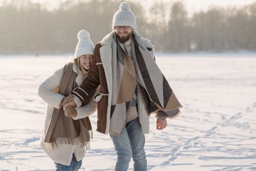 Cute Couple on a Snow Covered Ground 