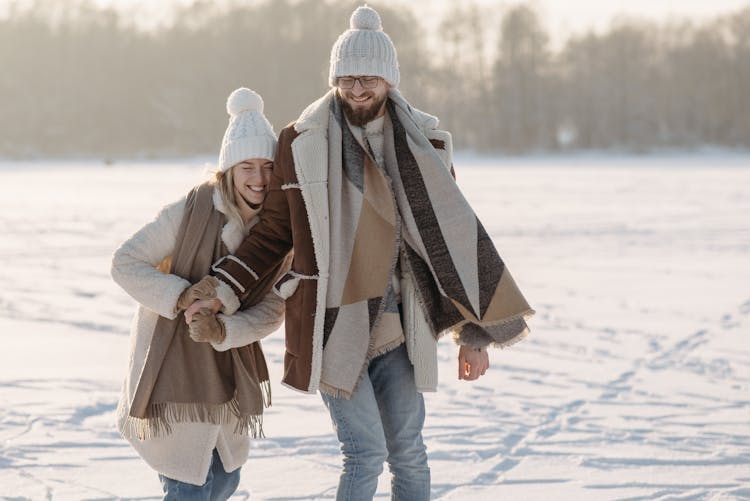 Cute Couple On A Snow Covered Ground 