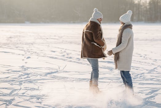 A couple enjoying ice skating together on a snowy day, showcasing winter fun and love.
