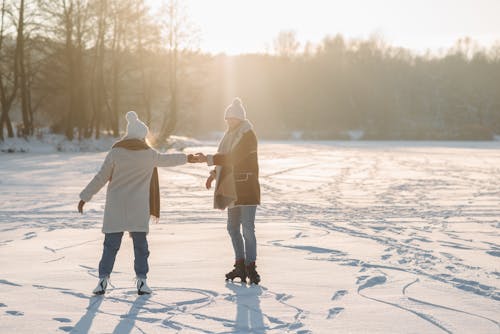 Couple Holding Hands While Doing Ice Skating