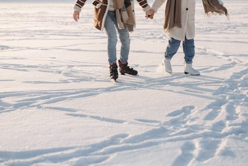 A  Couple Holding Hands while Ice Skating