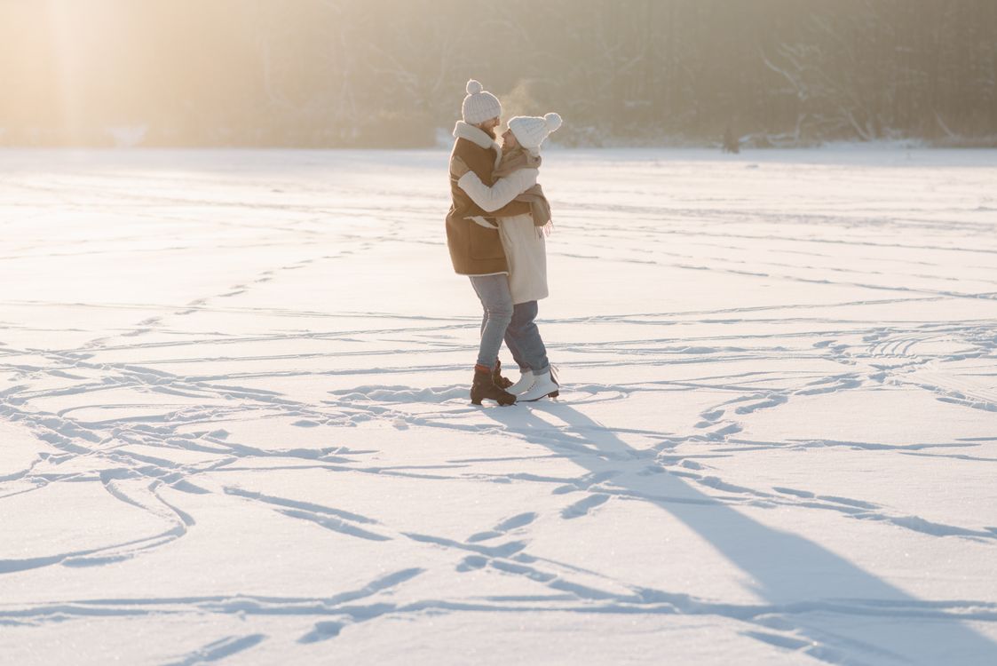 A Couple Embracing while Standing on Snow · Free Stock Photo