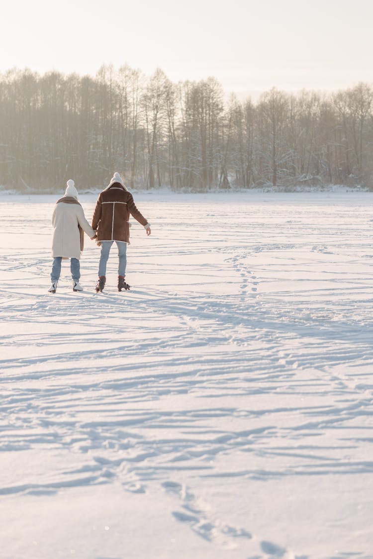 A Couple Skating On Snow 