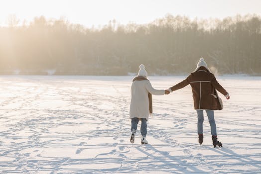 A couple skating together on a snowy day, holding hands outdoors, capturing winter romance.