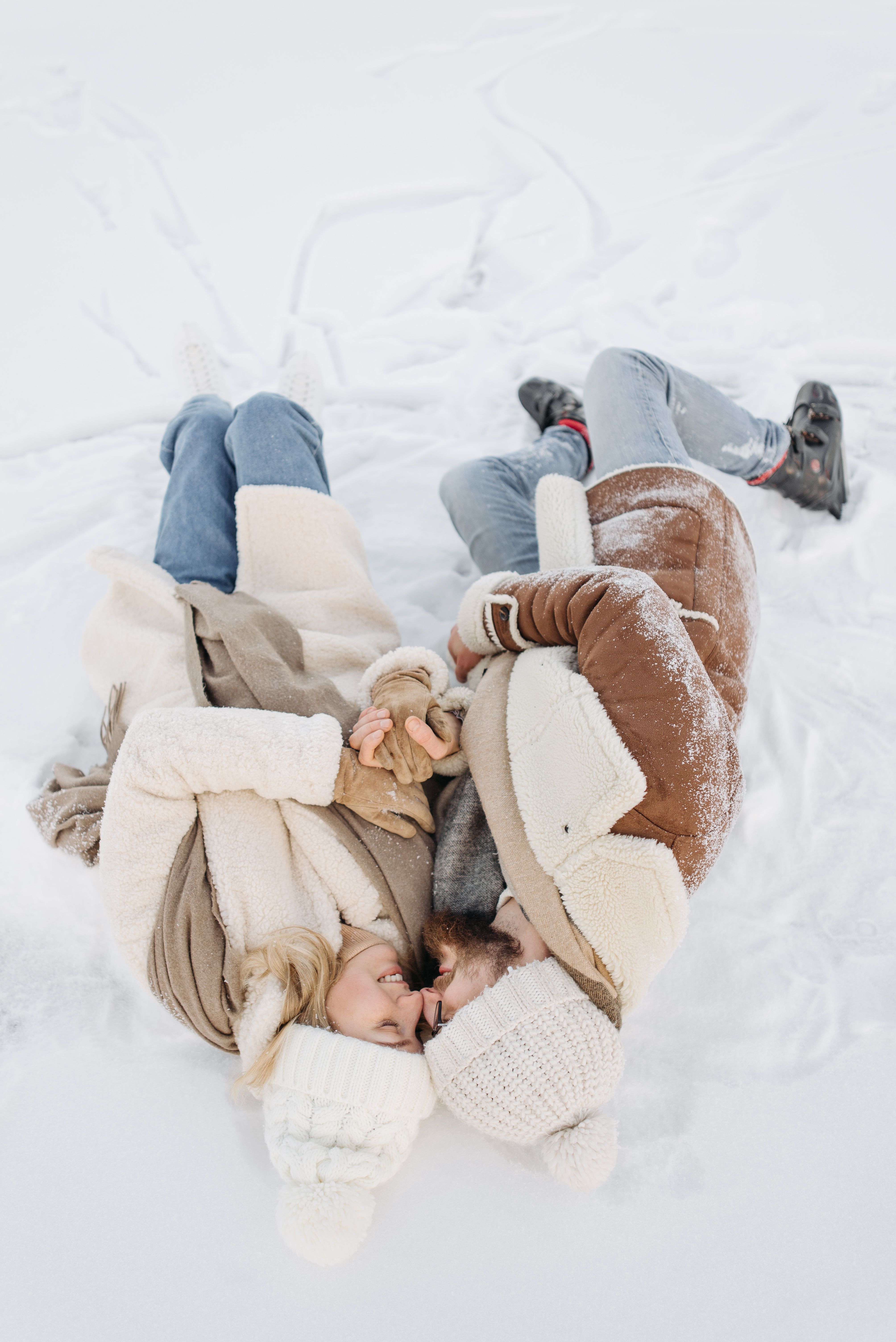 Couple Lying on Snow Covered Ground · Free Stock Photo