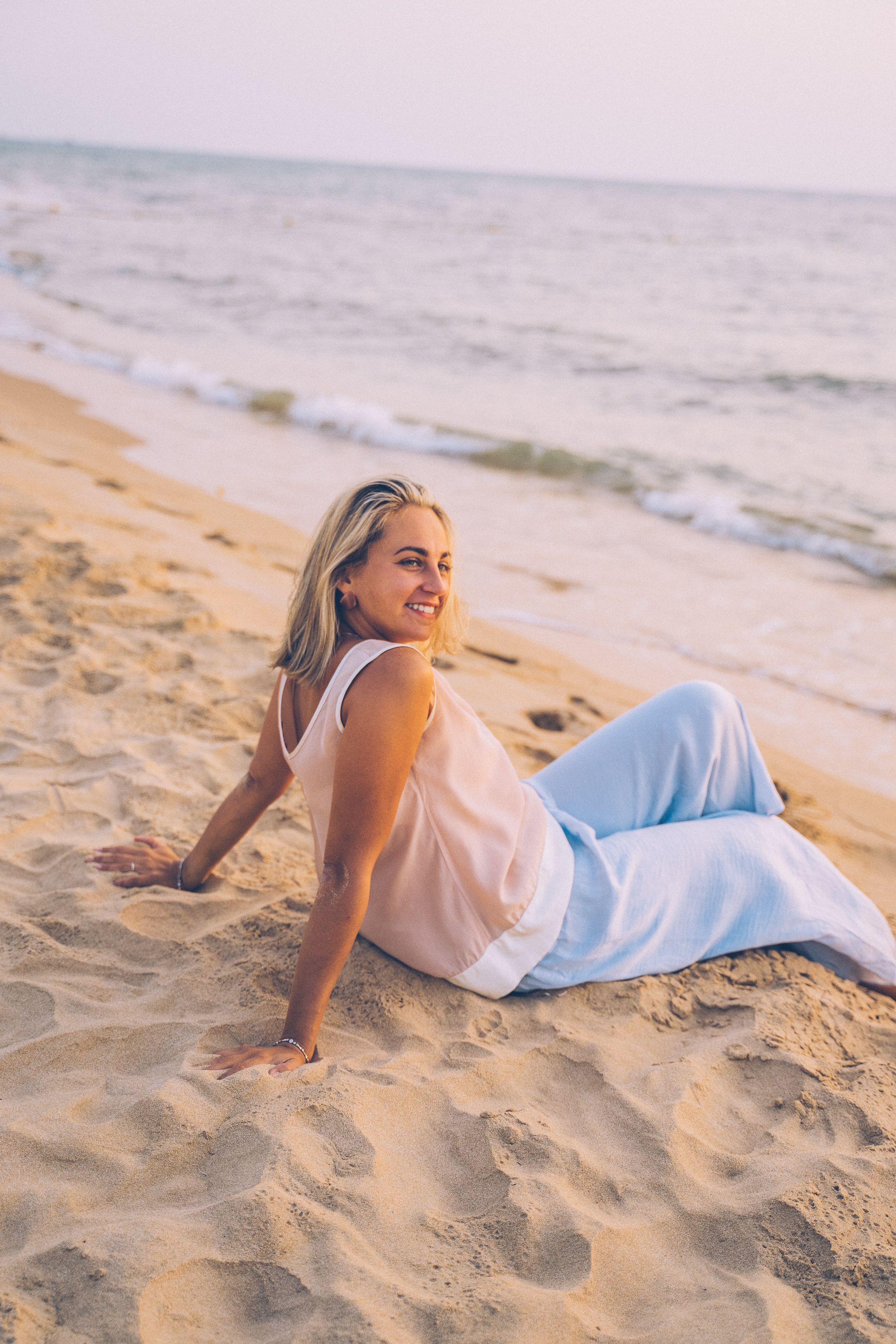 Woman in Brown Bikini Sitting on Beach · Free Stock Photo