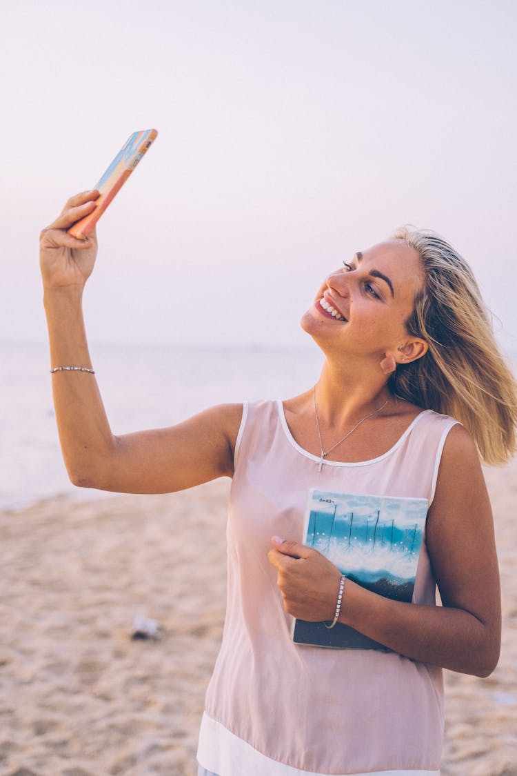 Woman Taking Selfie At The Beach