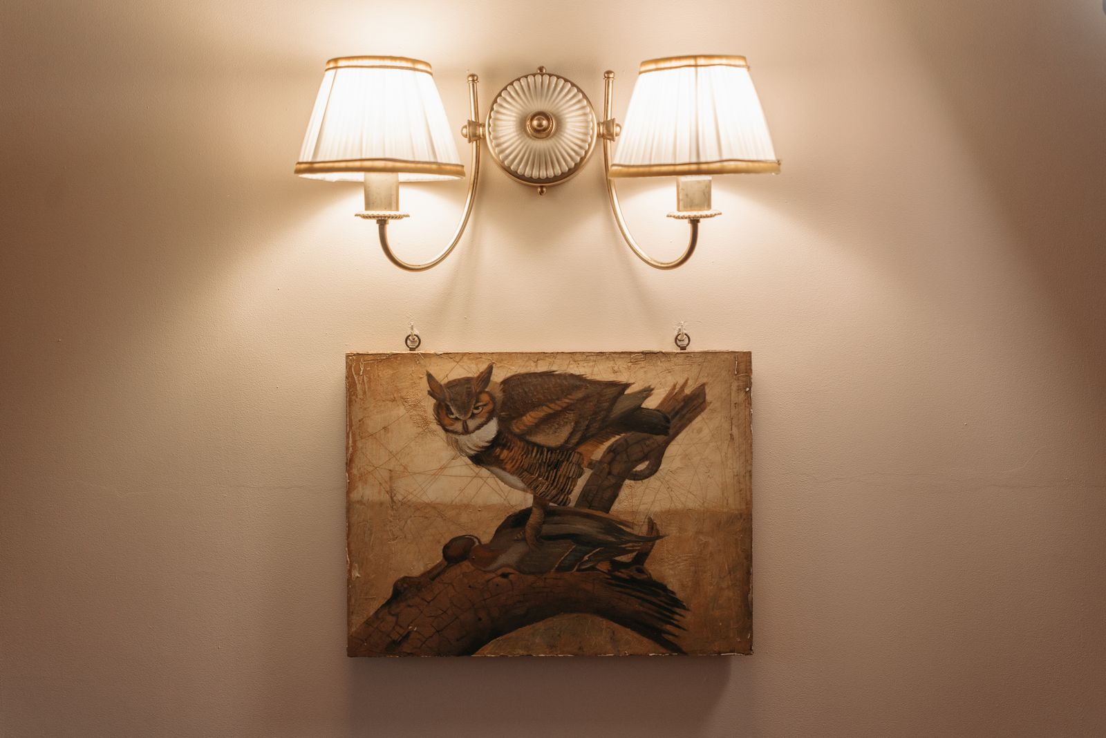 Paired sconces washing a neutral wall in warm light — photo by Pavel Danilyuk on Pexels