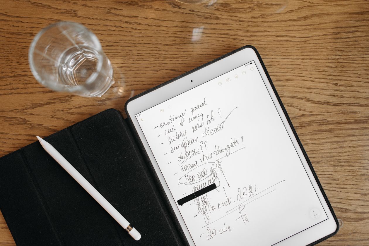 A close-up of pen and paper with handwritten notes and ink swatches — fountain pen ink testing