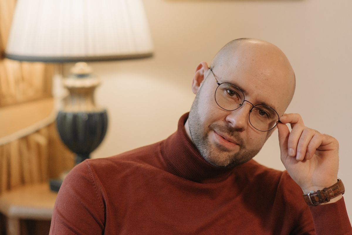 Person in a warm lamplit room facing the camera, photo by Pavel Danilyuk on Pexels
