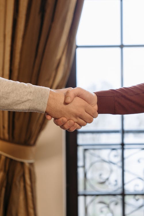 Free People in Long Sleeves Shaking Hands Stock Photo