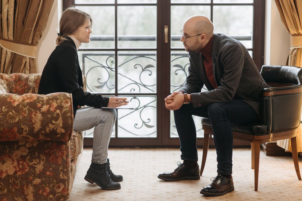 A couple talking through challenges with their therapist