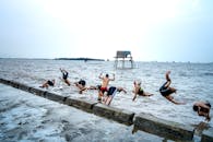 Group of local boys diving into sea