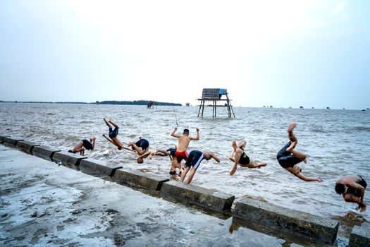 Group of local boys diving into sea