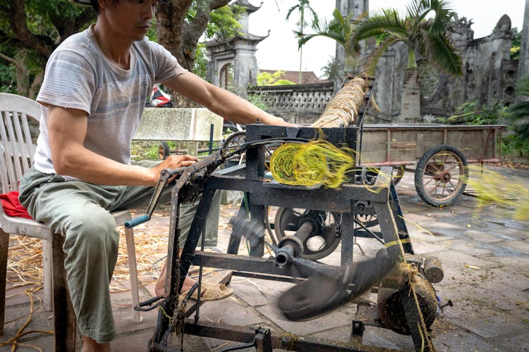 Crop Asian Worker Cutting Tobacco Roll On Press Machine