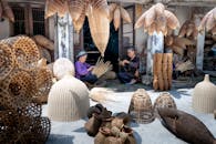 Elderly Vietnamese women working and making wicker bamboo fish traps