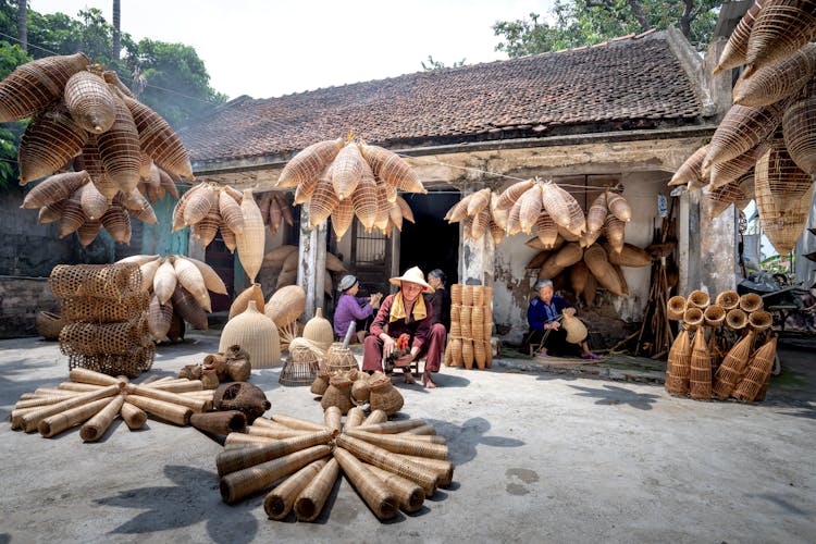 Different Bamboo Fish Traps In Rustic Yard With Vietnamese People