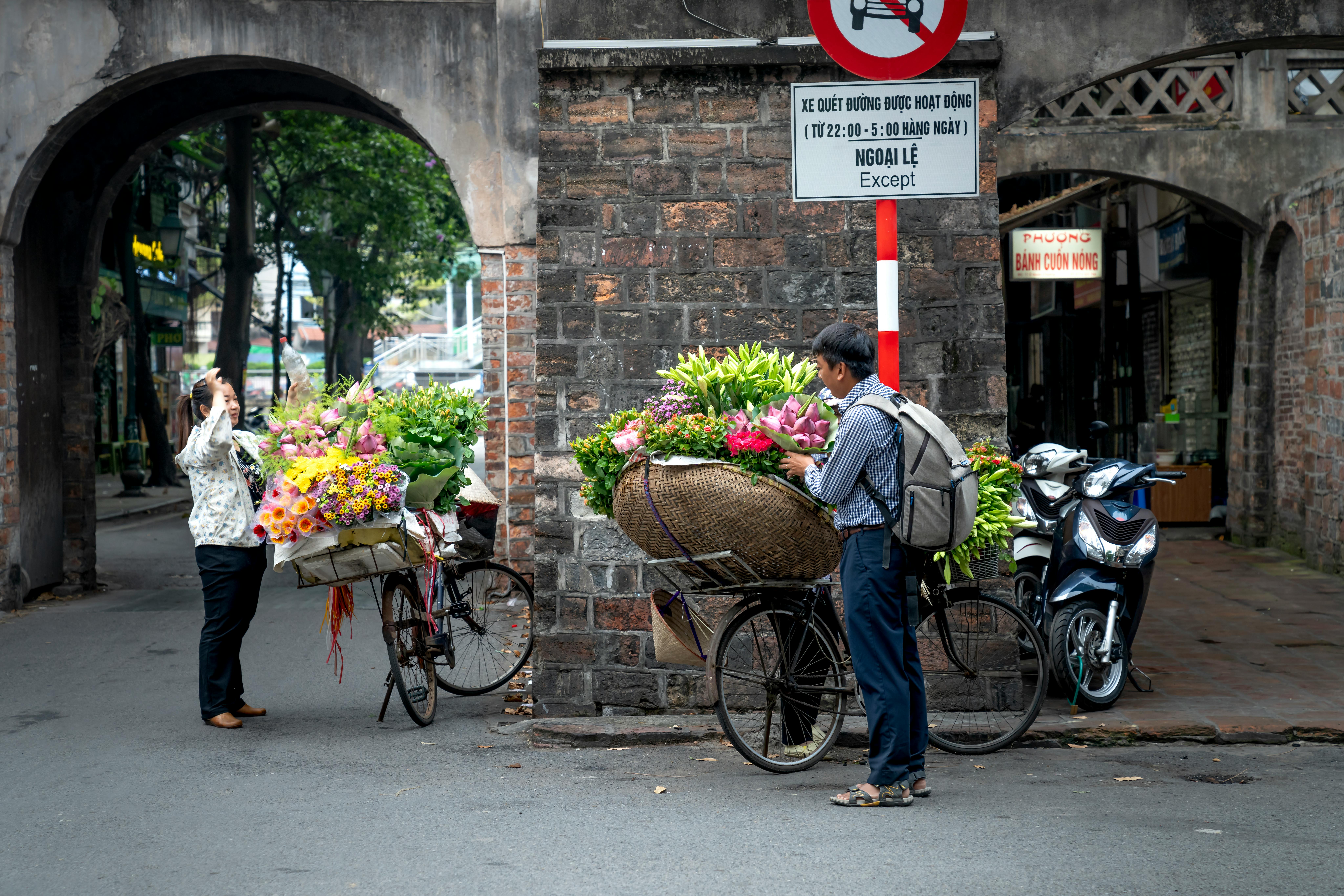 man in casual clothes buying flowers on street