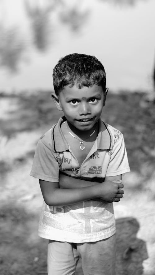 Free Grayscale Photo of Boy Looking at Camera Stock Photo