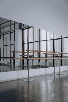 Modern ballet studio featuring mirrored walls and ballet barres, perfect for dance practice.