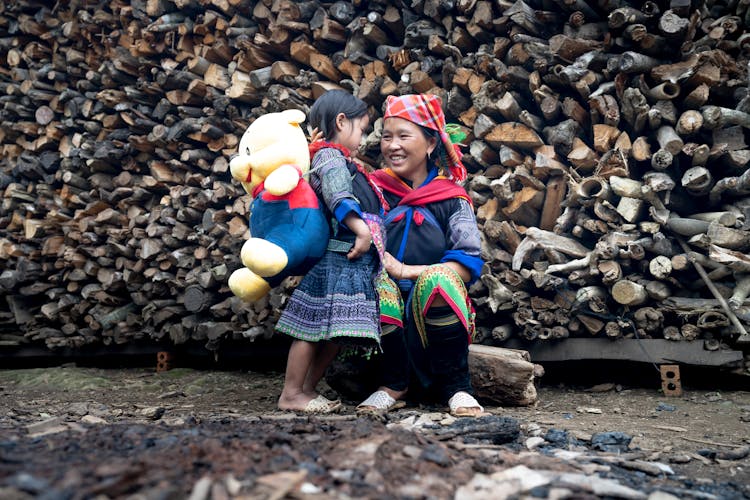 Mother And Daughter With A Huge Teddy Bear In A Rural Area In Asia 