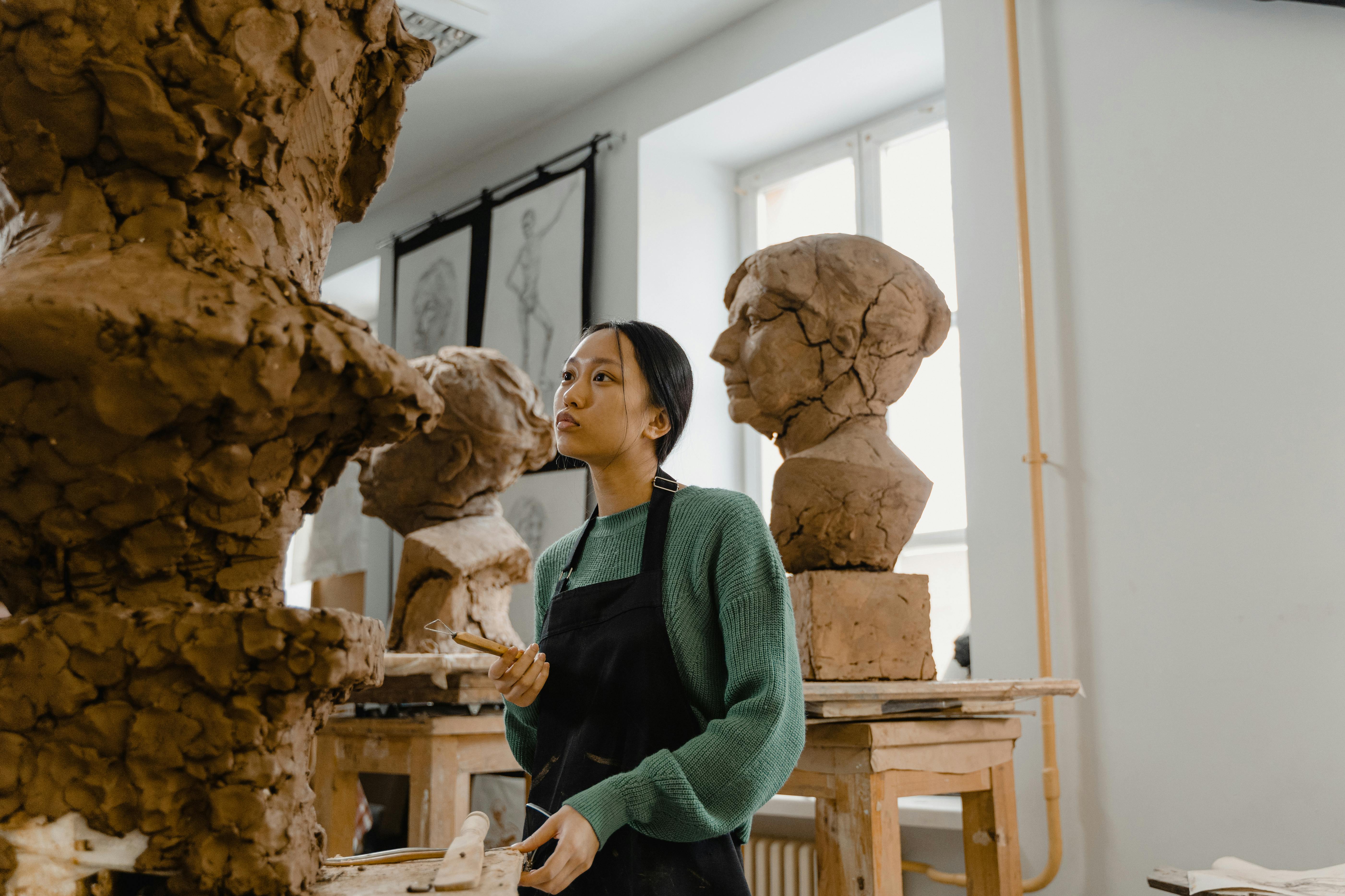 A Woman Looking at a Clay Sculpture