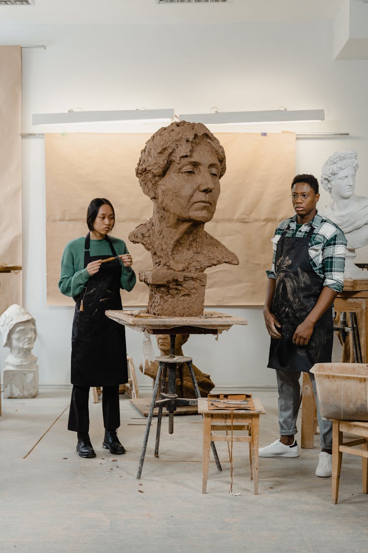 Man And Woman Standing Beside The Statue