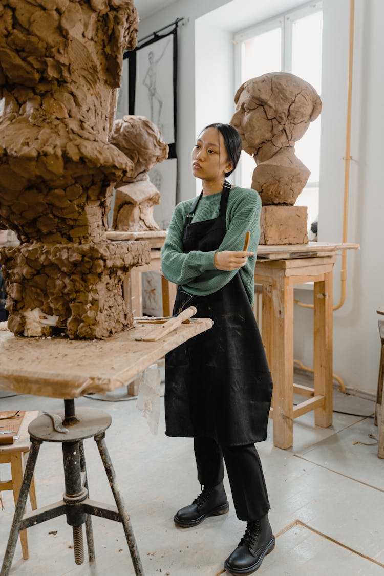 A Sculptor Surrounded By Clay Sculptures