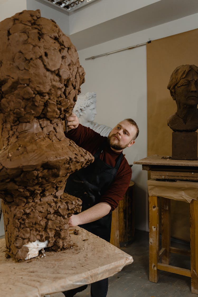 A Sculptor Working At An Art Studio