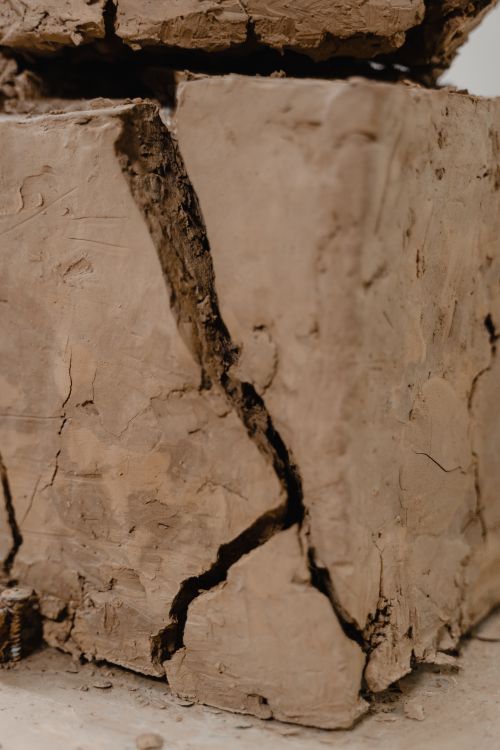 Free Close-up of a cracked clay block showcasing its intricate textures and raw surface details. Stock Photo