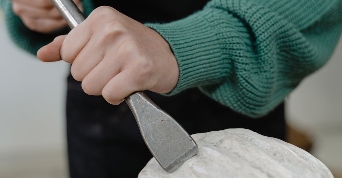 A Person Using a Hammer and a Chisel · Free Stock Photo