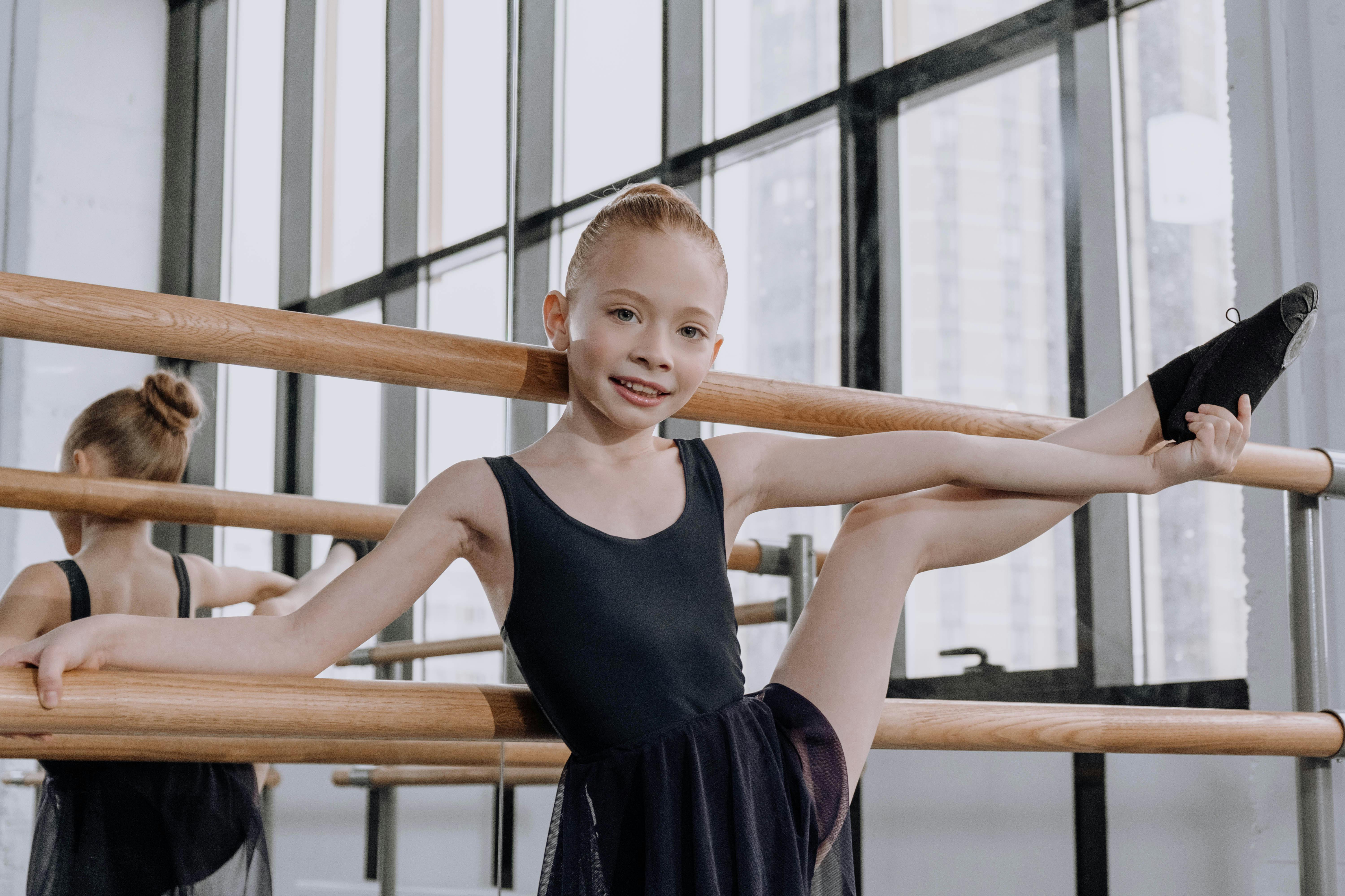 Girl in Black Leotard Doing Ballet Stretching · Free Stock Photo