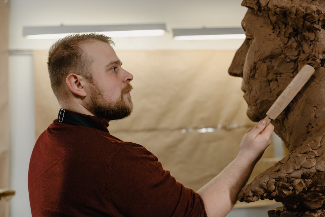 A Man Sculpting Clay · Free Stock Photo