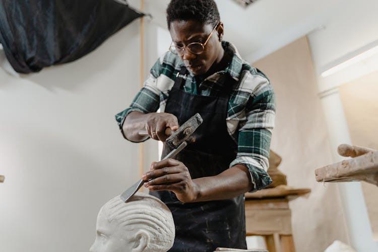 A Sculptor Working On A Sculpture