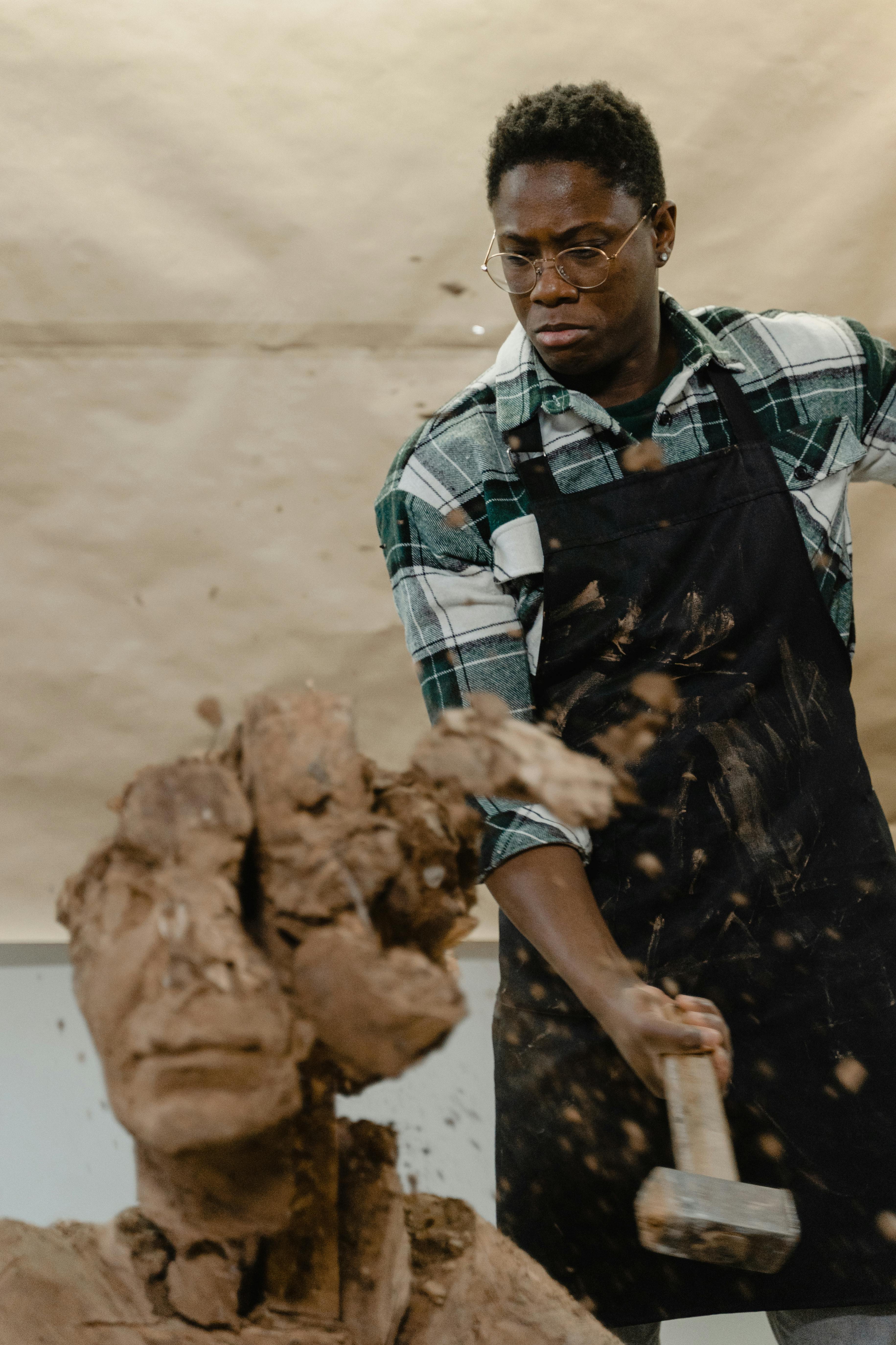 A Man Hammering a Sculpture · Free Stock Photo