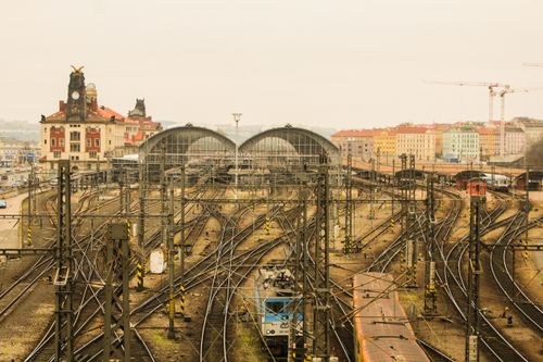 Free Railway tracks converging at Prague's historic train station under a cloudy sky. Stock Photo