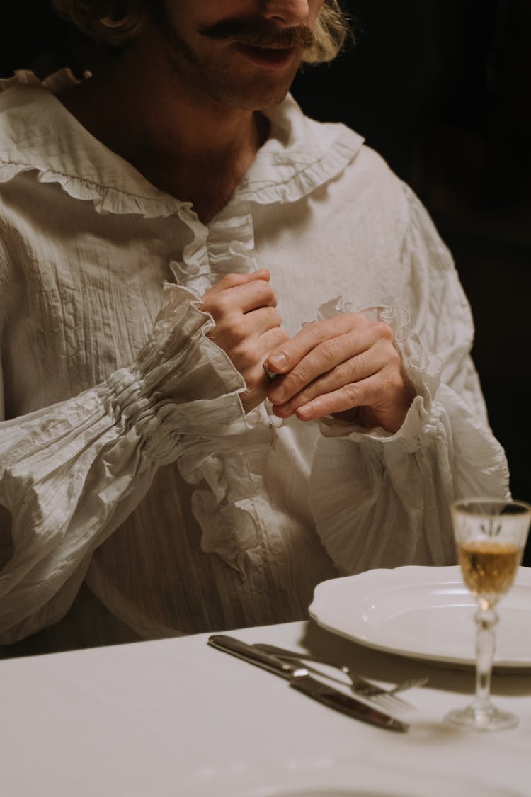  Aristocrat Sitting At A Dinner Table Clutching A Signet Ring