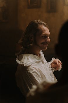 Elegant portrait of a man in vintage attire with soft lighting and historic ambiance.