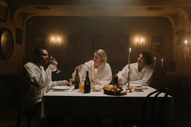 A Group Of Men In Medieval Wear Drinking Wine