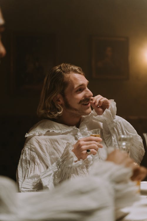 A Man Wearing Medieval Outfit Drinking Alcohol