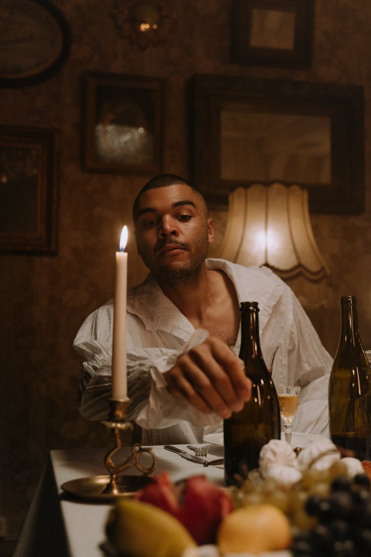 A Man Wearing White Ruffle Long Sleeves Shirt