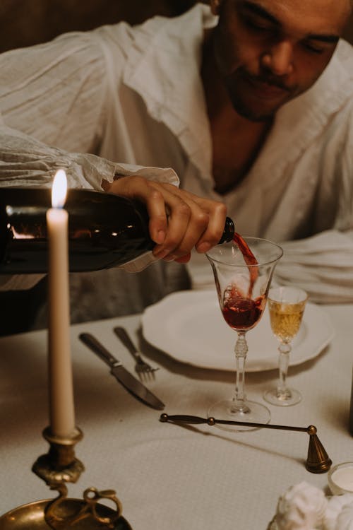 A Man Pouring Red Wine in a glass