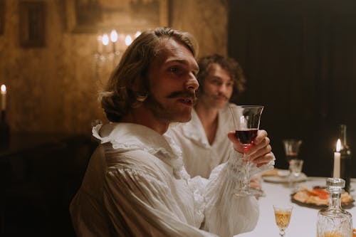 A Man Holding a Glass of Wine