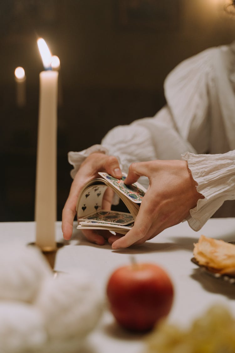 A Person Shuffling Cards