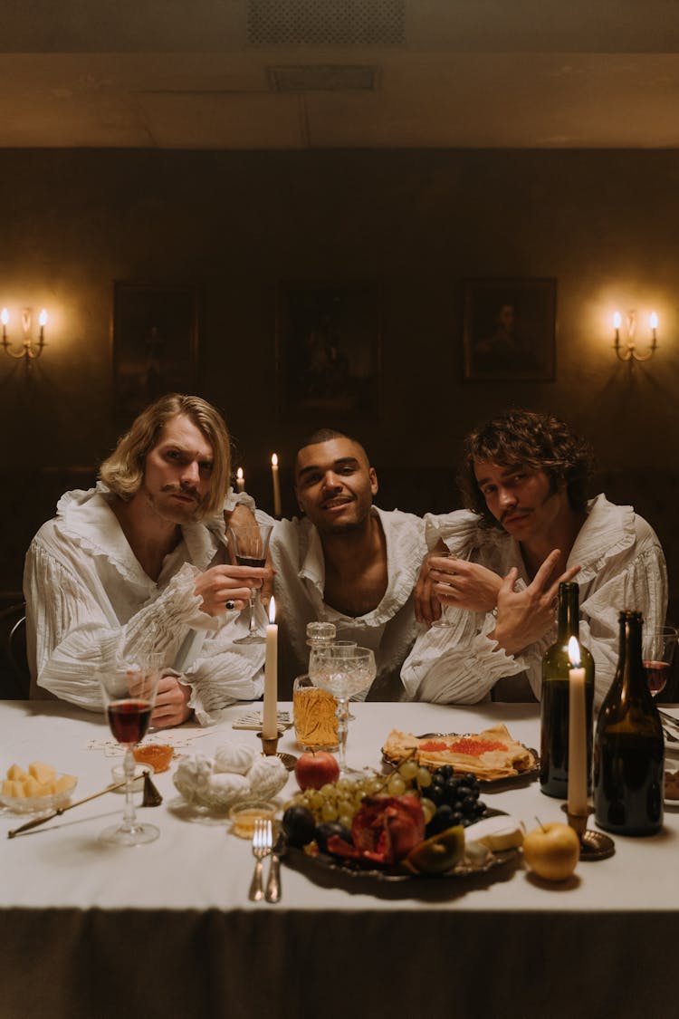 Men Wearing Long Sleeve Shirts Sitting At Table 