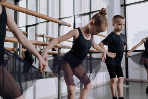 Free Young ballet dancers in a studio perfecting their ballet poses in black outfits. Stock Photo