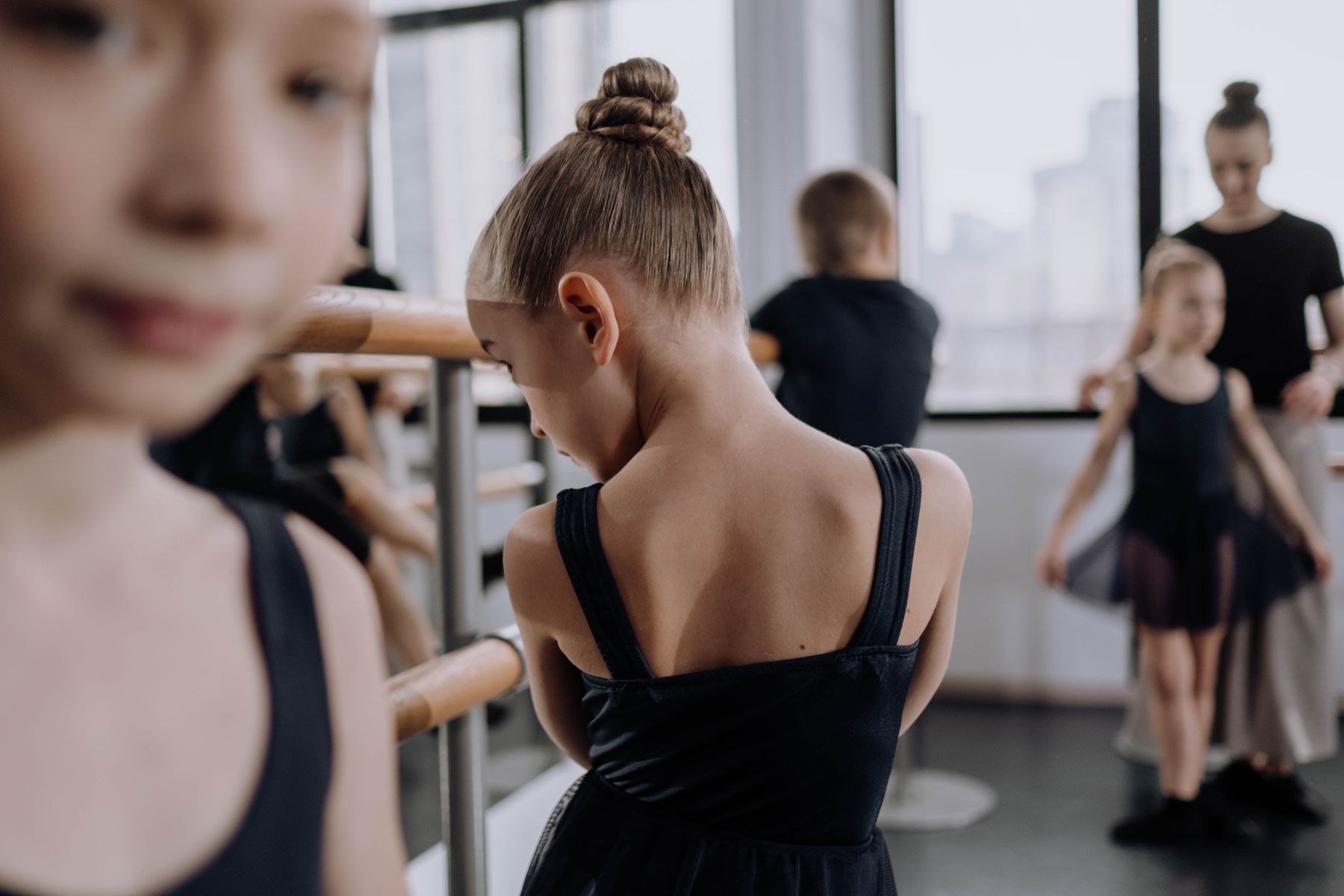 Young girls learning ballet together in a studio