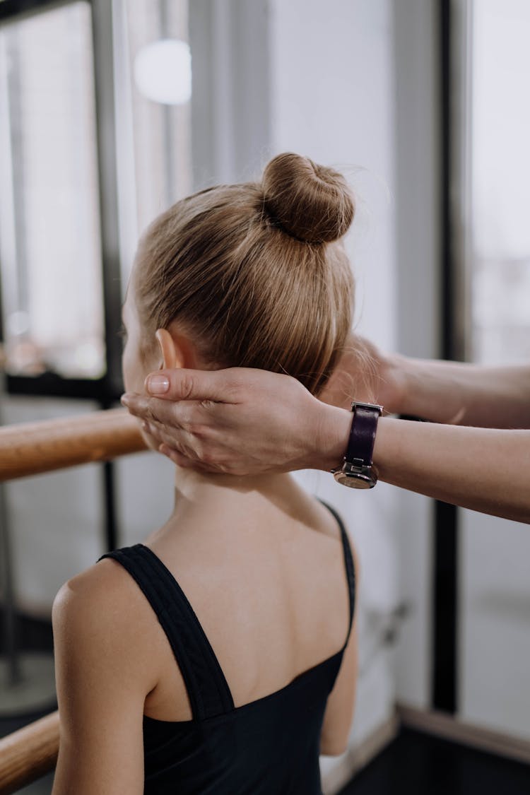 A Person Touching A Ballerina On The Neck