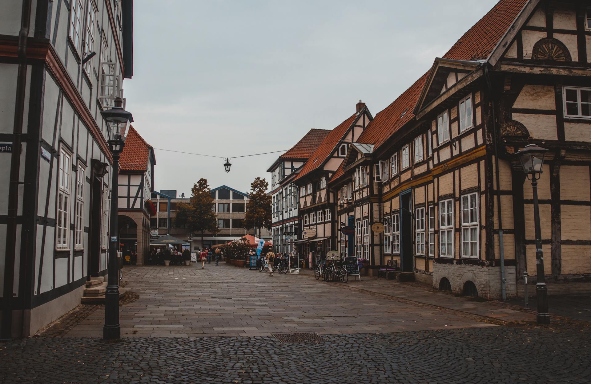 Picturesque cobblestone street scene in a quaint town featuring historic architecture and a lively atmosphere.