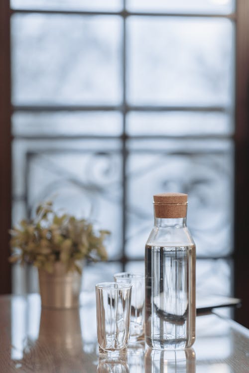 Glass Bottle with Water on the Table